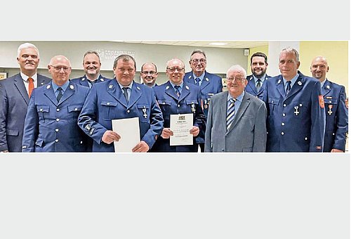 Eine Gruppe von Männern in Feuerwehruniform. Mit dabei auch der Bürgermeister Timo Ehrhardt und der stellvertretende Landrat Bernd Steger, beide im Anzug.